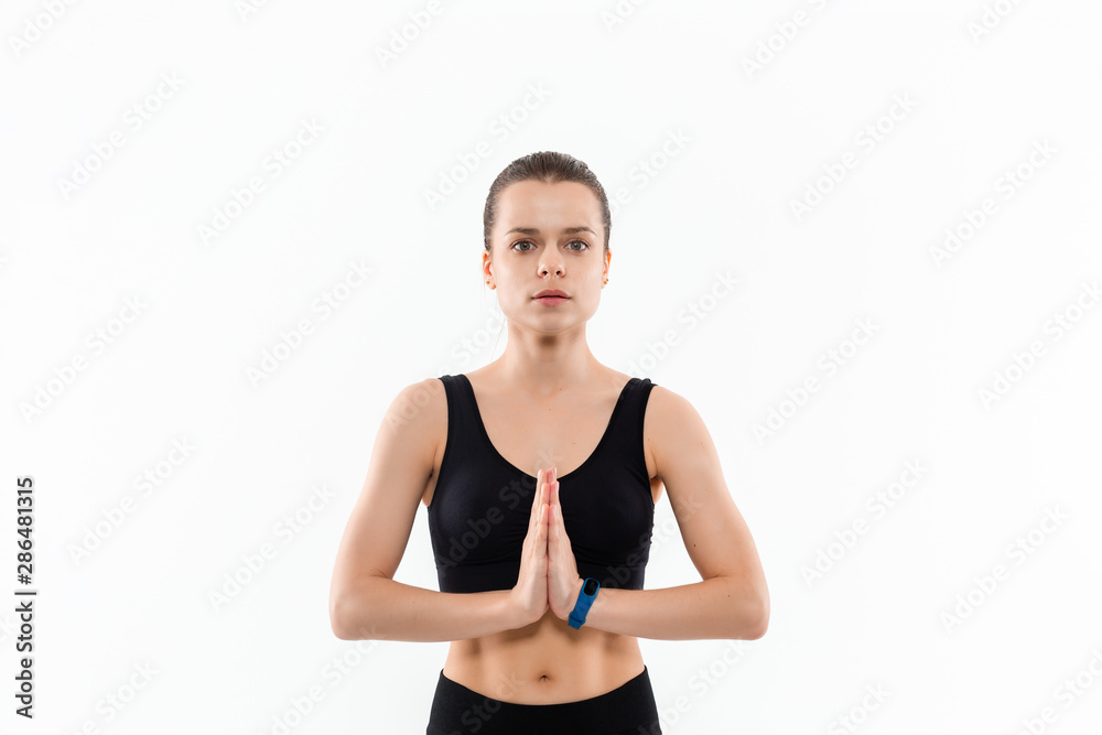 Young sporty blond woman in a black sportswear relaxing after exercising isolated over white background. Young sporty blond woman in a black sportswear relaxing after exercising isolated over white background.