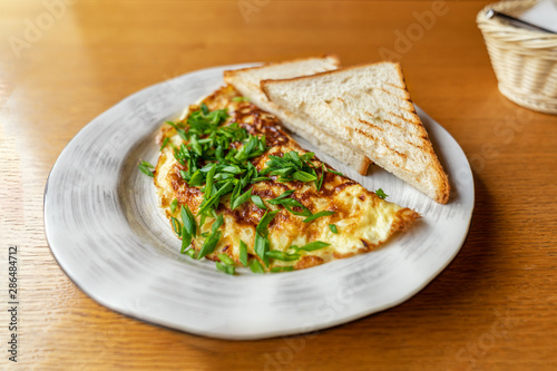 Green onion Omelette with Bread Toasts on Plate. delicious, easy and popular Breakfast