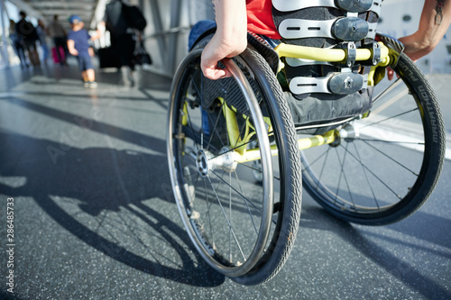 Young woman in wheelchair in a corridor