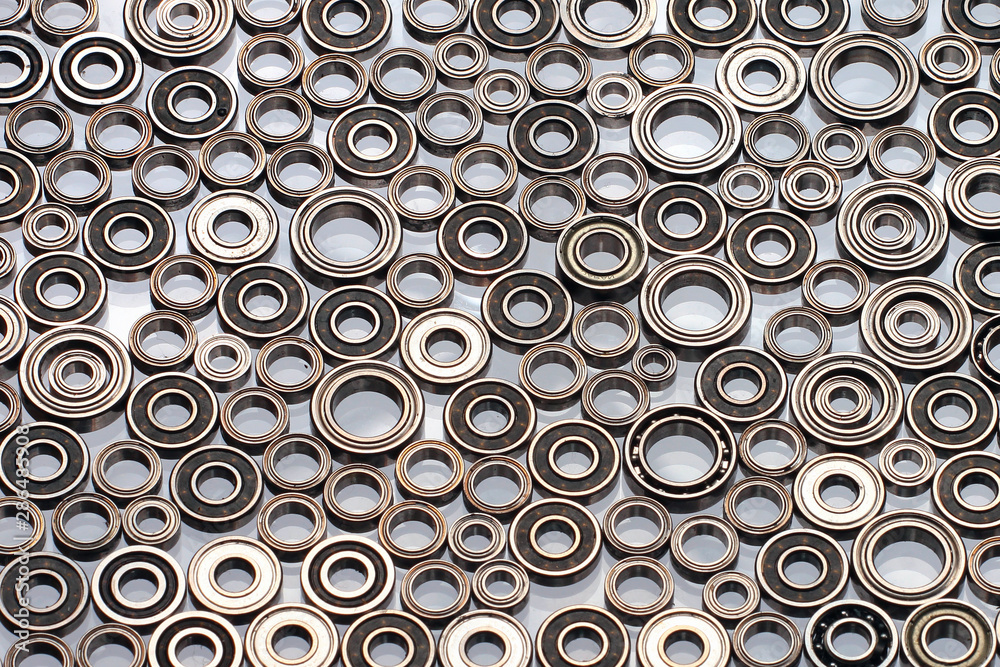Many small ball bearings on white background Many small ball bearings on white background