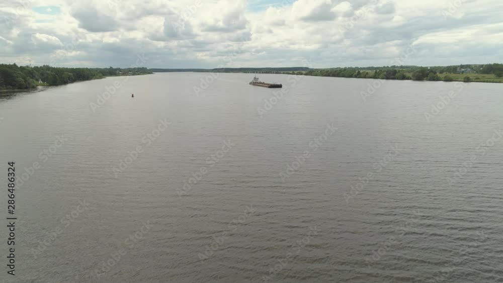 Aerial view:Barge with cargo on the river Volga. River tugboat moves cargo barge, Cargo ship on the river. Aerial view:Barge with cargo on the river Volga. River tugboat moves cargo barge, Cargo ship on the river.