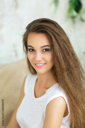 Beauty woman with white perfect smile looking at camera at home