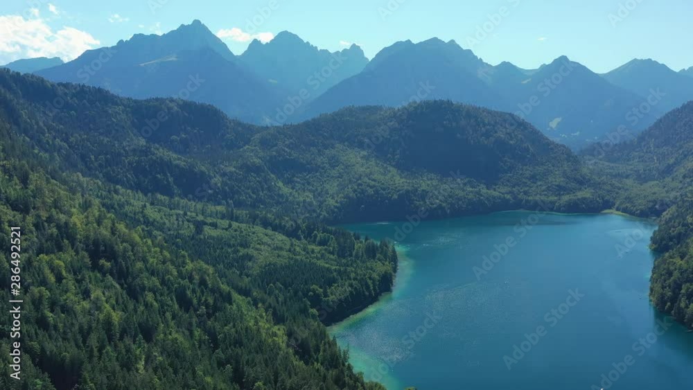 Aerial view of Bavarian Alps mountains in summer, deep waters of picturesque lake Alpsee - landscape panorama of Bavaria from above, Germany, Europe Aerial view of Bavarian Alps mountains in summer, deep waters of picturesque lake Alpsee - landscape panorama of Bavaria from above, Germany, Europe