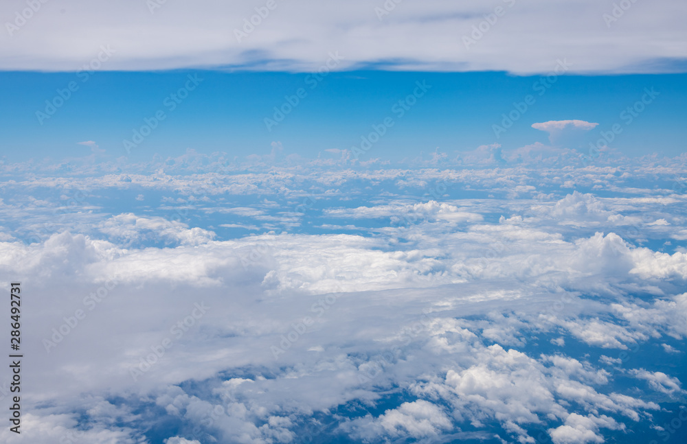 The blue sky and white clouds at an altitude of 10,000 meters under the sun The blue sky and white clouds at an altitude of 10,000 meters under the sun