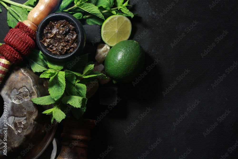bowl with tobacco for hookah. fruits on a black background bowl with tobacco for hookah. fruits on a black background