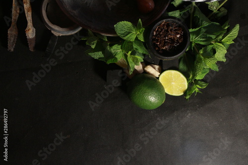 bowl with tobacco for hookah. berries on a black background