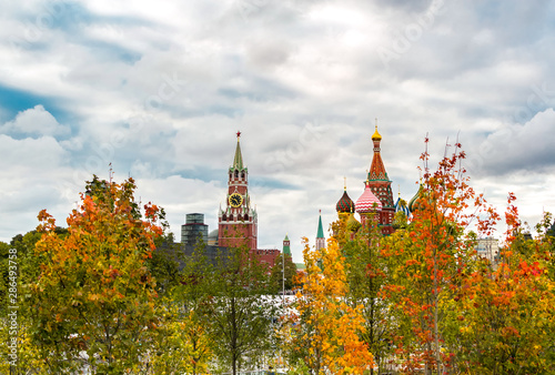 Long view of the Kremlin and St. Basil's Cathedral with colorful trees on an autumn day