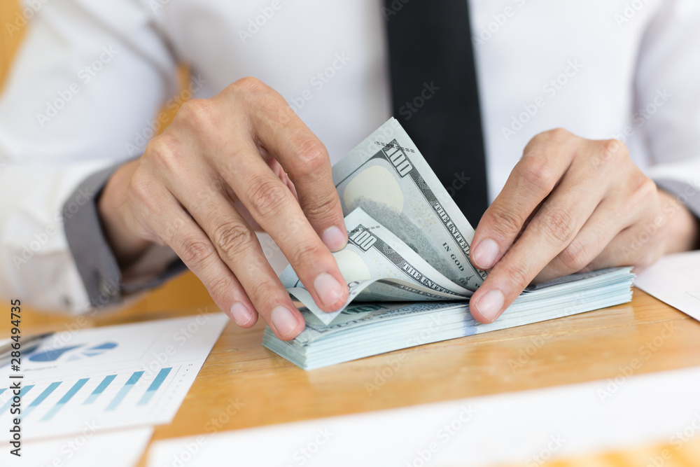 Fototapeta premium Toned picture,Men using hands to count dollar bills