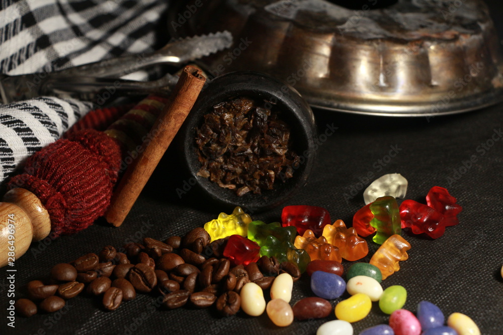 bowl with tobacco for hookah. berries on a black background bowl with tobacco for hookah. berries on a black background