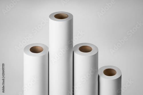 Blank white paper rolls isolated on gray background. Mockup paper for magazines, catalogs or newspapers isolated on gray backdrop, Printing house theme or wrapping paper for presents