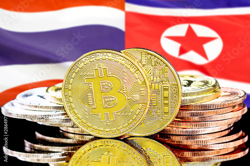 Concept for investors in cryptocurrency and Blockchain technology in the Thailand and North Korea. Bitcoins on the background of the flag Thailand and North Korea.