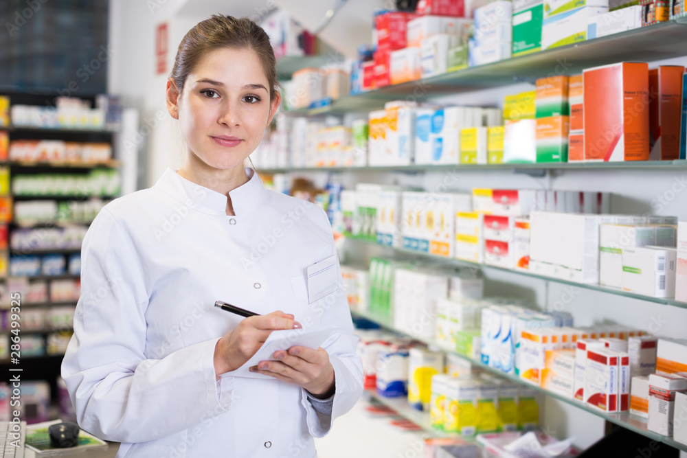 Woman pharmacist is inventorying medicines