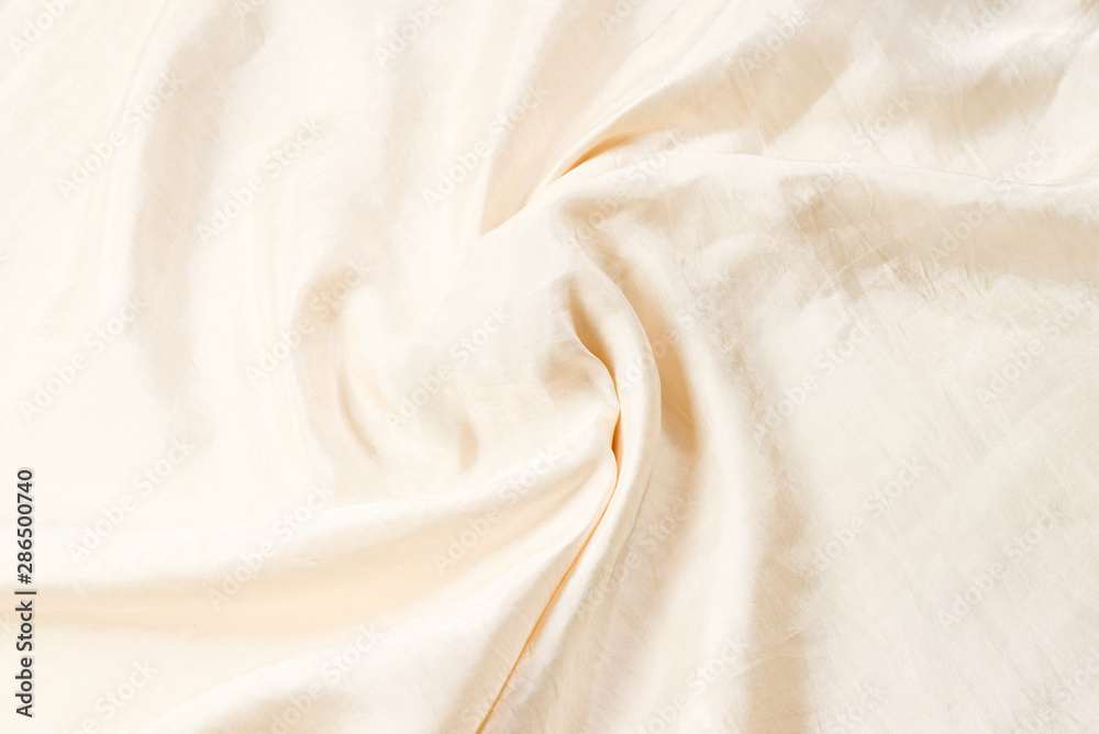 Soft smooth beige silk fabric background. Fabric texture. Soft smooth beige silk fabric background. Fabric texture.