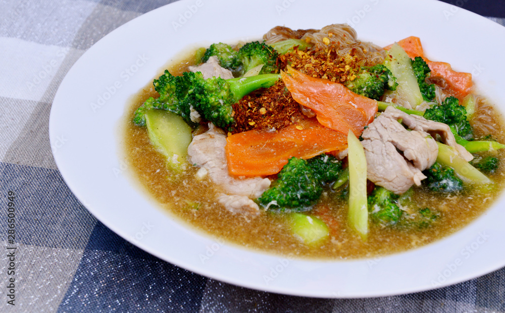 pork and Broccoli and carrot in thick gravy with thin rice noodles pork and Broccoli and carrot in thick gravy with thin rice noodles