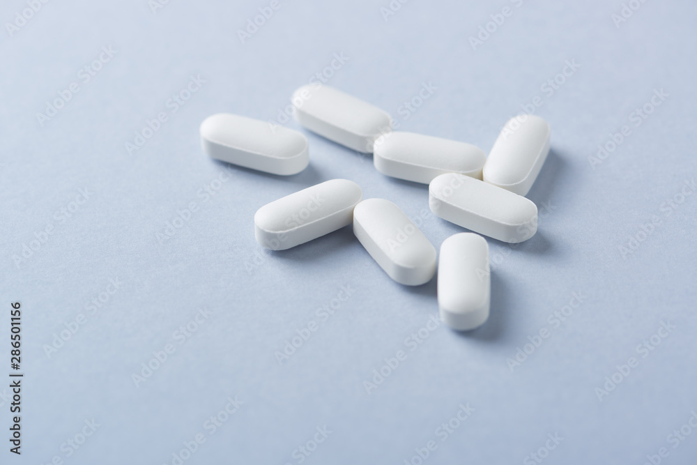 Lysine tablets. Concept for a healthy dietary supplementation. Nervous System Support. Bright background. Close up. Copy space. Lysine tablets. Concept for a healthy dietary supplementation. Nervous System Support. Bright background. Close up. Copy space.