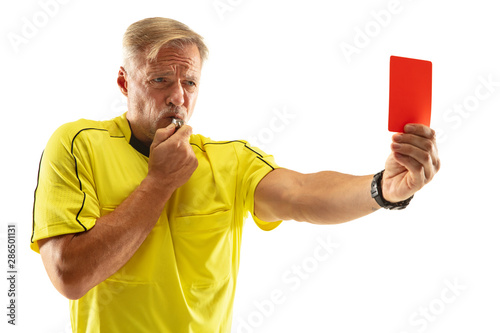 Referee showing a red card and gesturing to a football or soccer player while gaming isolated on white studio background. Concept of sport, rules violation, controversial issues, obstacles overcoming.