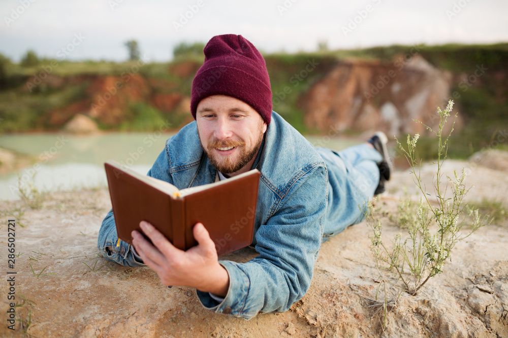 The researcher makes notes in a notebook lying on a quarry of white clay