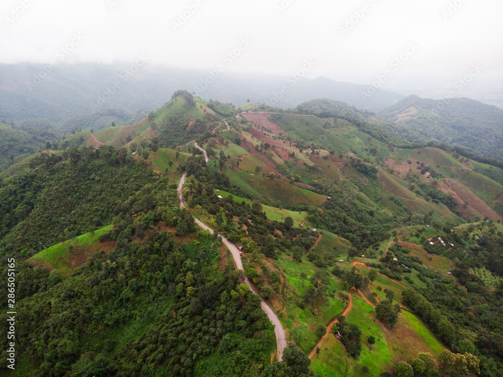 The aerial view on the mountains with beautiful winding roads suitable for holiday travel.