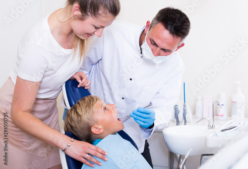 Mother with child are visiting dentist