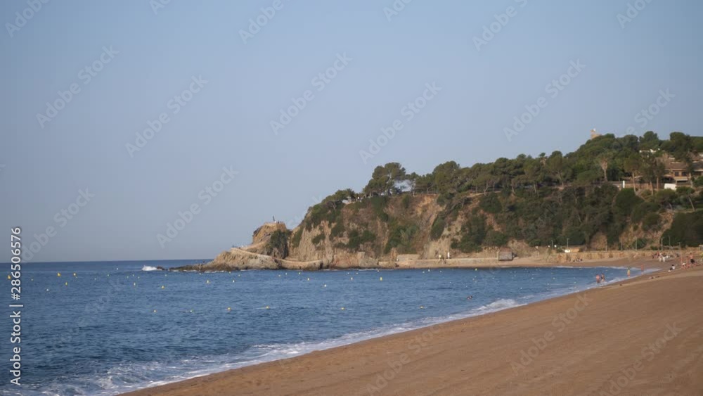 Beautiful beach resort on the ocean. At the end of the beach is a mountain. 4K Slow Mo Beautiful beach resort on the ocean. At the end of the beach is a mountain. 4K Slow Mo