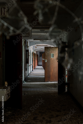 Derelict Hallway with Open Doors + Broken Glass - Abandoned Rockland State Hospital - New York photo