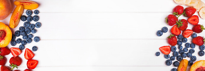 Summer banner with fruits and berries on the white wooden background