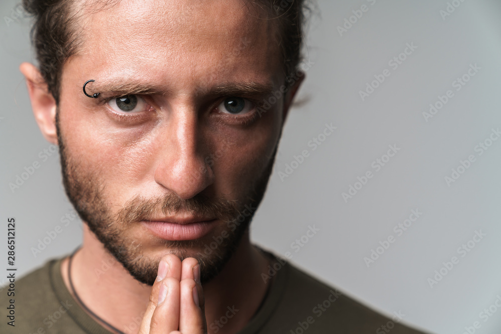 Concentrated young man standing isolated over gray Concentrated young man standing isolated over gray