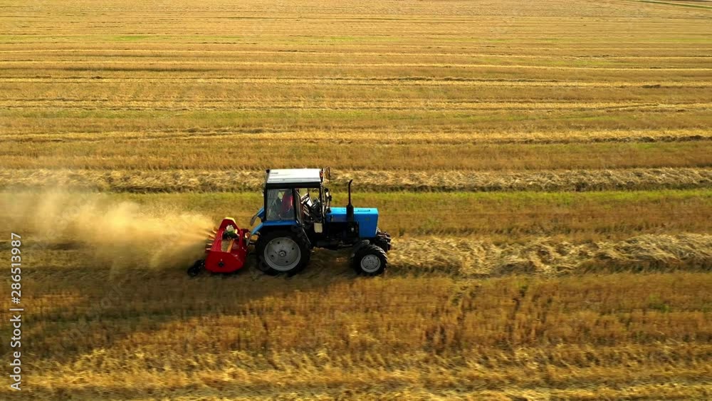 Tractors and farm machines harvesting corn in Autumn, breathtaking aerial view. Tractors and farm machines harvesting corn in Autumn, breathtaking aerial view.