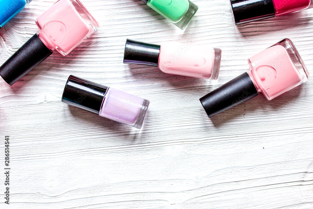 lot of bottles nail polish on wooden background top view lot of bottles nail polish on wooden background top view
