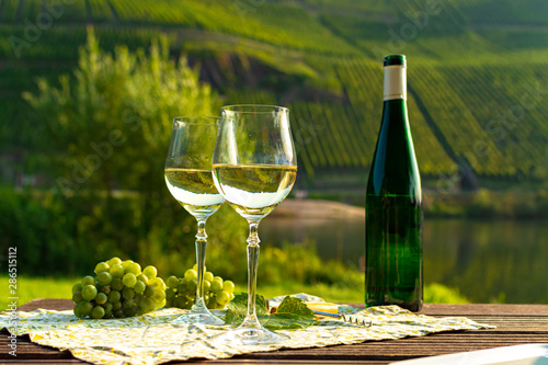 Famous German quality white wine riesling, produced in Mosel wine regio from white grapes growing on slopes of hills in Mosel river valley in Germany photo
