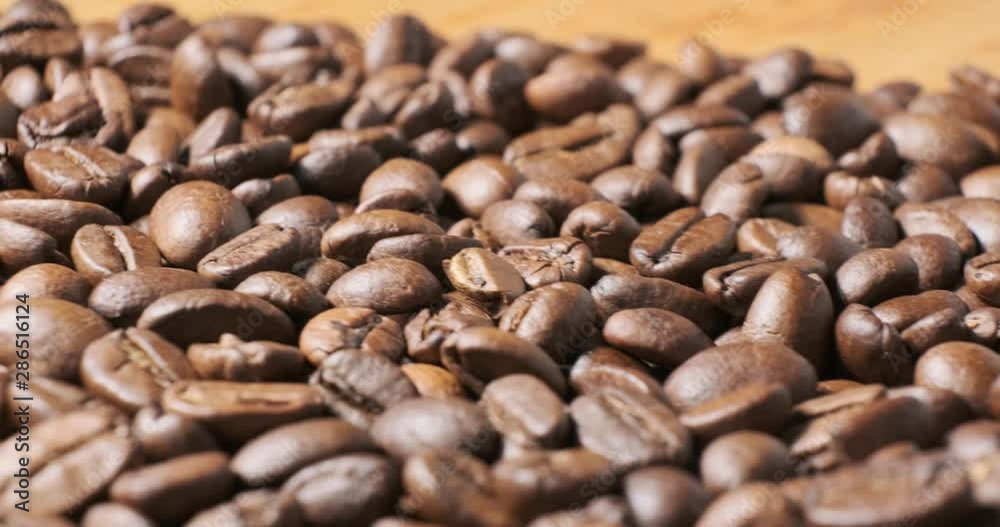 Coffee beans close up isolated sliding movement Coffee beans close up isolated sliding movement