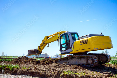 Excavator is digging on building site