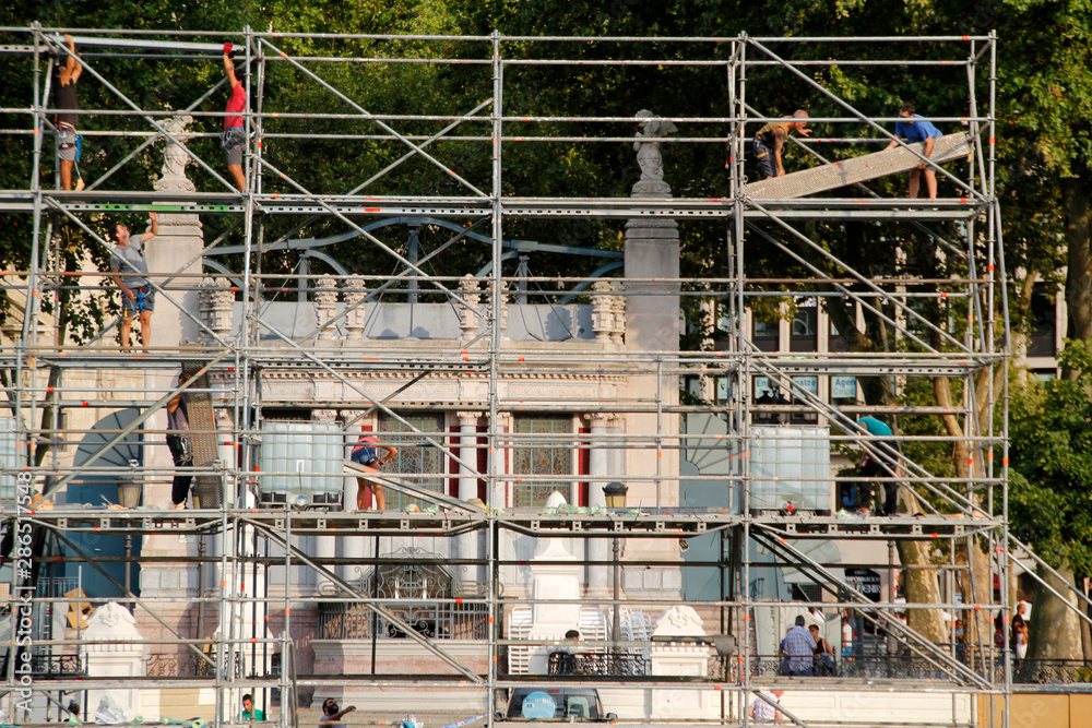 Dessambling a scaffolding in a construction site Dessambling a scaffolding in a construction site