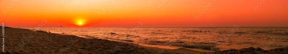 Sunset - sun reflecting in sea/ ocean, shore - panorama