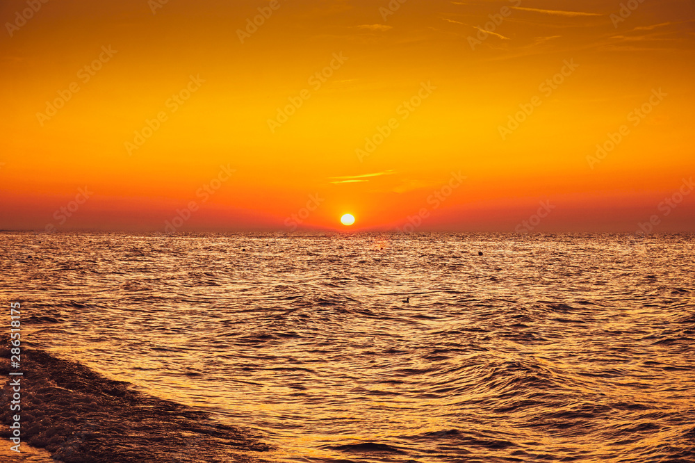 Sunset - sun reflecting in sea/ ocean, shore Sunset - sun reflecting in sea/ ocean, shore