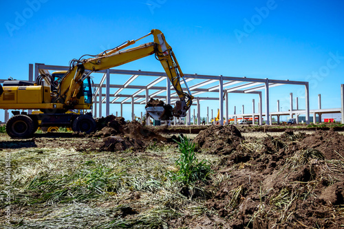 Excavator is digging on building site