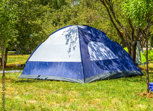Tent under the trees. Wild outdoor recreation.