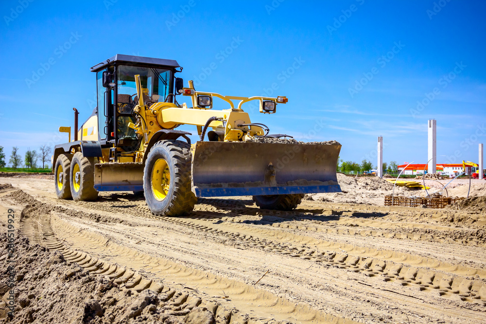 Grader is leveling ground at construction site Grader is leveling ground at construction site