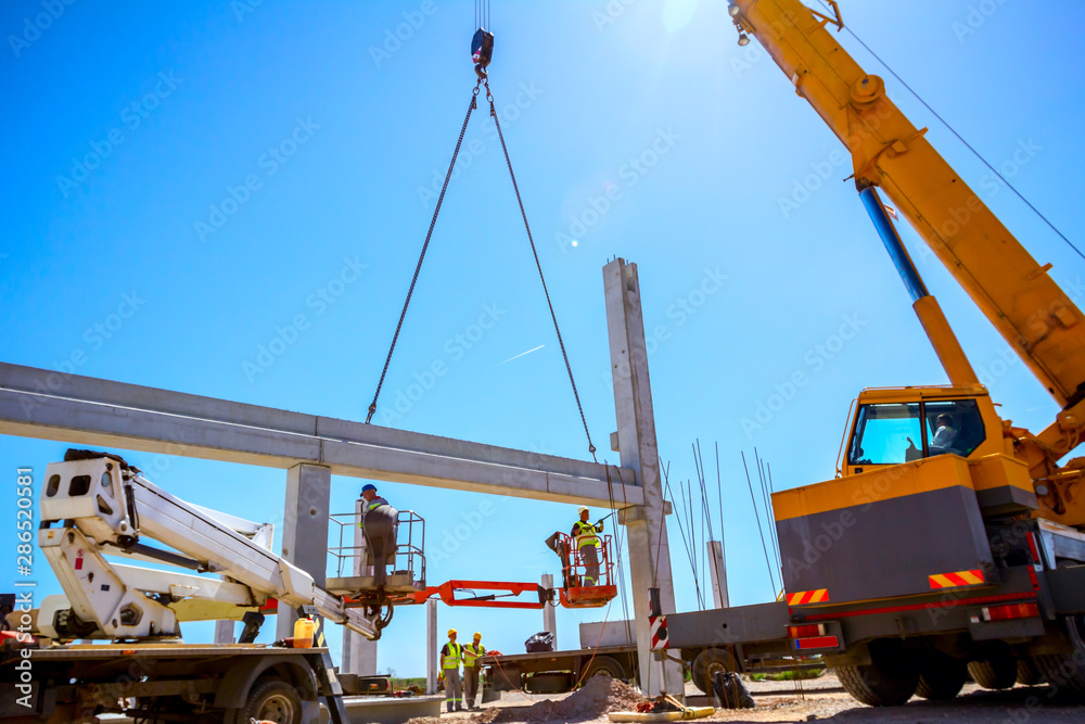 Mobile crane is carry concrete joist to assembly huge hall Mobile crane is carry concrete joist to assembly huge hall