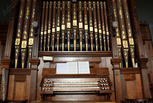 Closeup of an old pipe organ in a church.