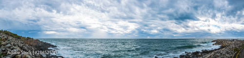 Panoramic view of ominous cloud formations on the coast.