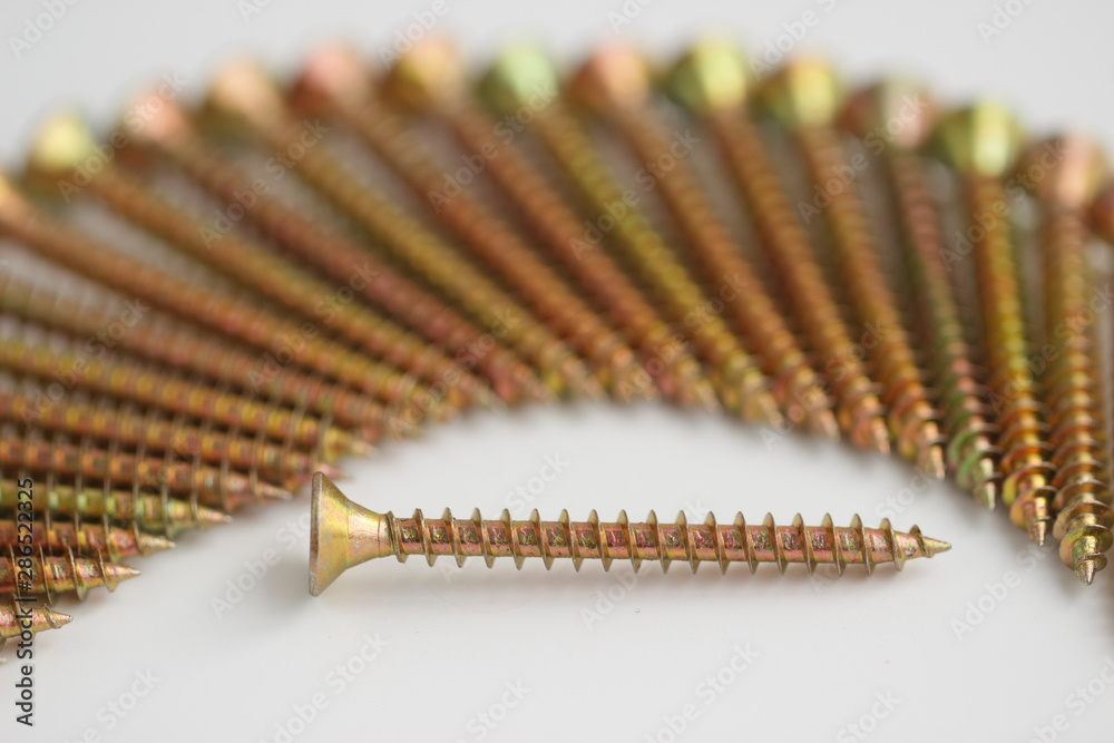 Tapping screw . Closeup yellow zinc coated screw isolate on white background. Tapping screw . Closeup yellow zinc coated screw isolate on white background.