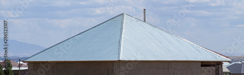 The roof of the house of the metal profile against the sky