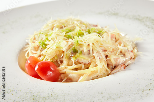 Delicious spaghetti carbonara with grated parmesan cheese