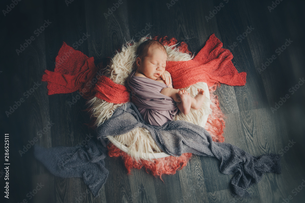 newborn baby wrapped in a blanket sleeping in a basket. concept of childhood, healthcare, IVF newborn baby wrapped in a blanket sleeping in a basket. concept of childhood, healthcare, IVF