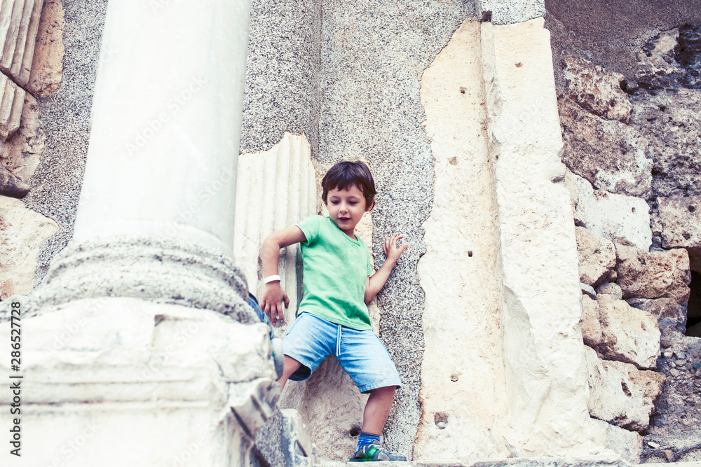 little boy exploring ancient architecture, lifestyle people on summer vacation close up