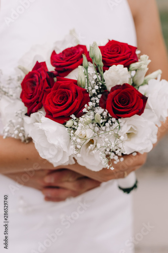 Wedding image and a bridal bouquet with red flowers 