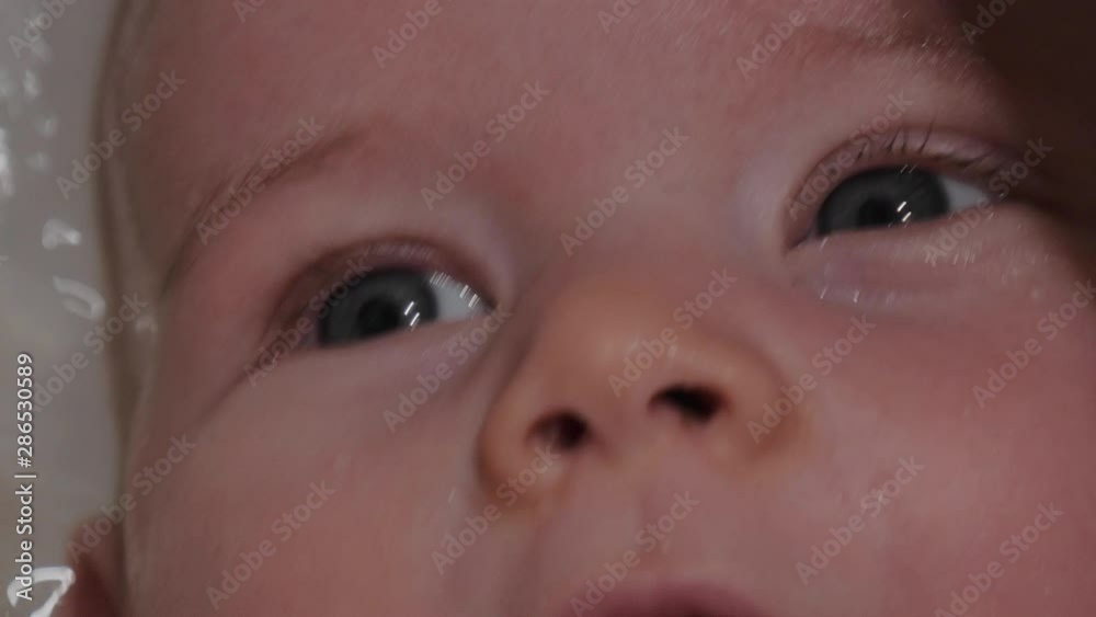 Closeup of a Baby's Face while Receiving Bath Closeup of a Baby's Face while Receiving Bath