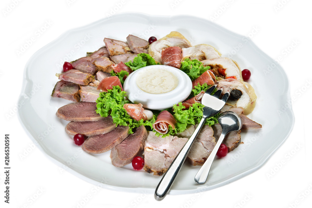 Sliced meat and sauce on a plate on an isolated white background Sliced meat and sauce on a plate on an isolated white background