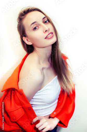 young pretty teenage hipster girl posing emotional happy smiling on white background, lifestyle people concept closeup